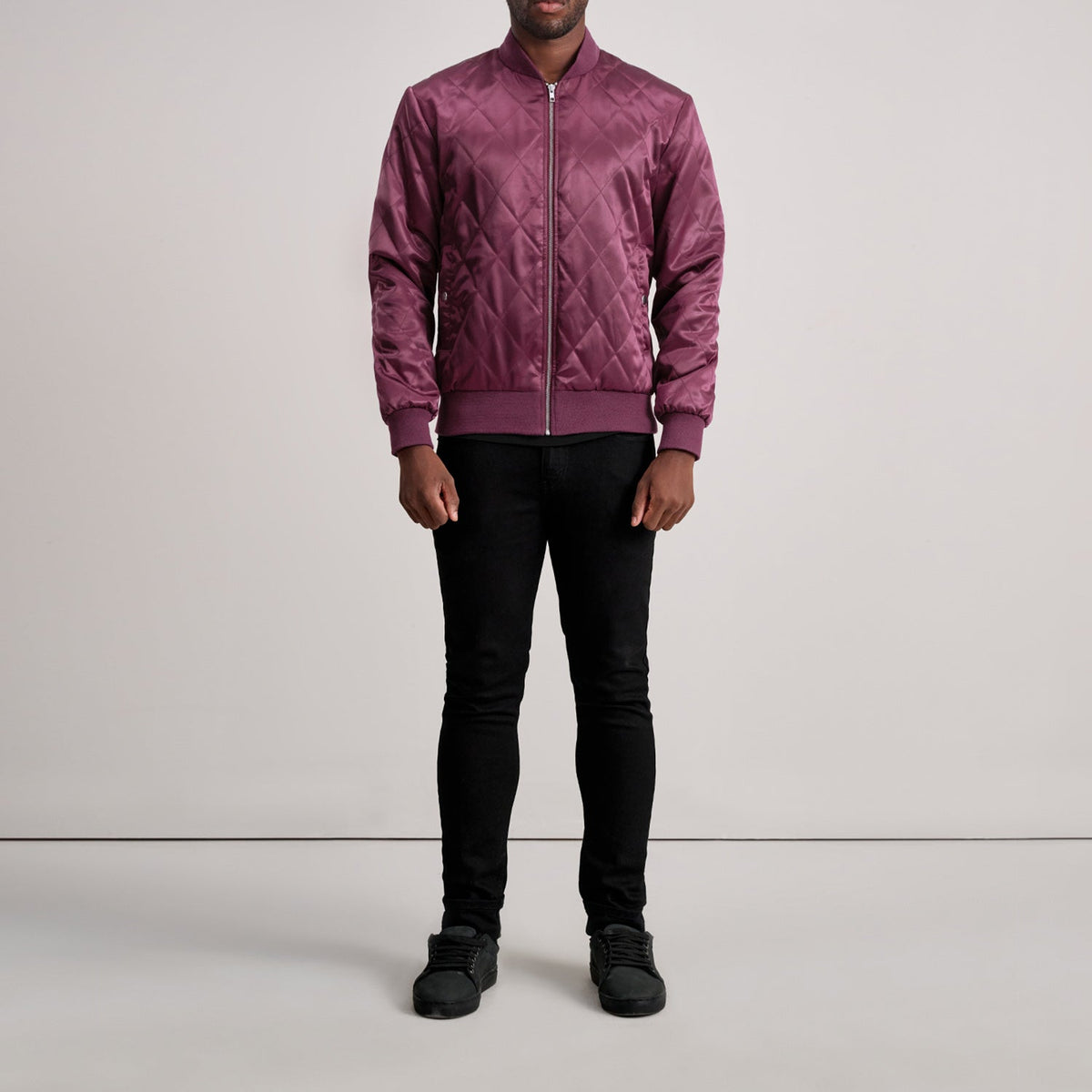 Close-Up Detail of Varsity & Zipper Hardware on Danson Quilted Maroon Varsity Jacket