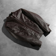 
Détail de confection artisanale de l'ourlet sur Rumella Maroon Leather Biker Jacket